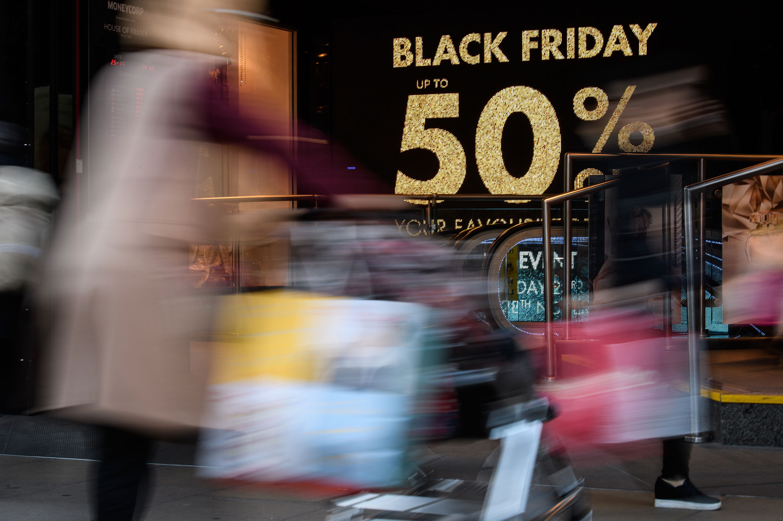 Blurred crowds in front of a Black Friday sign