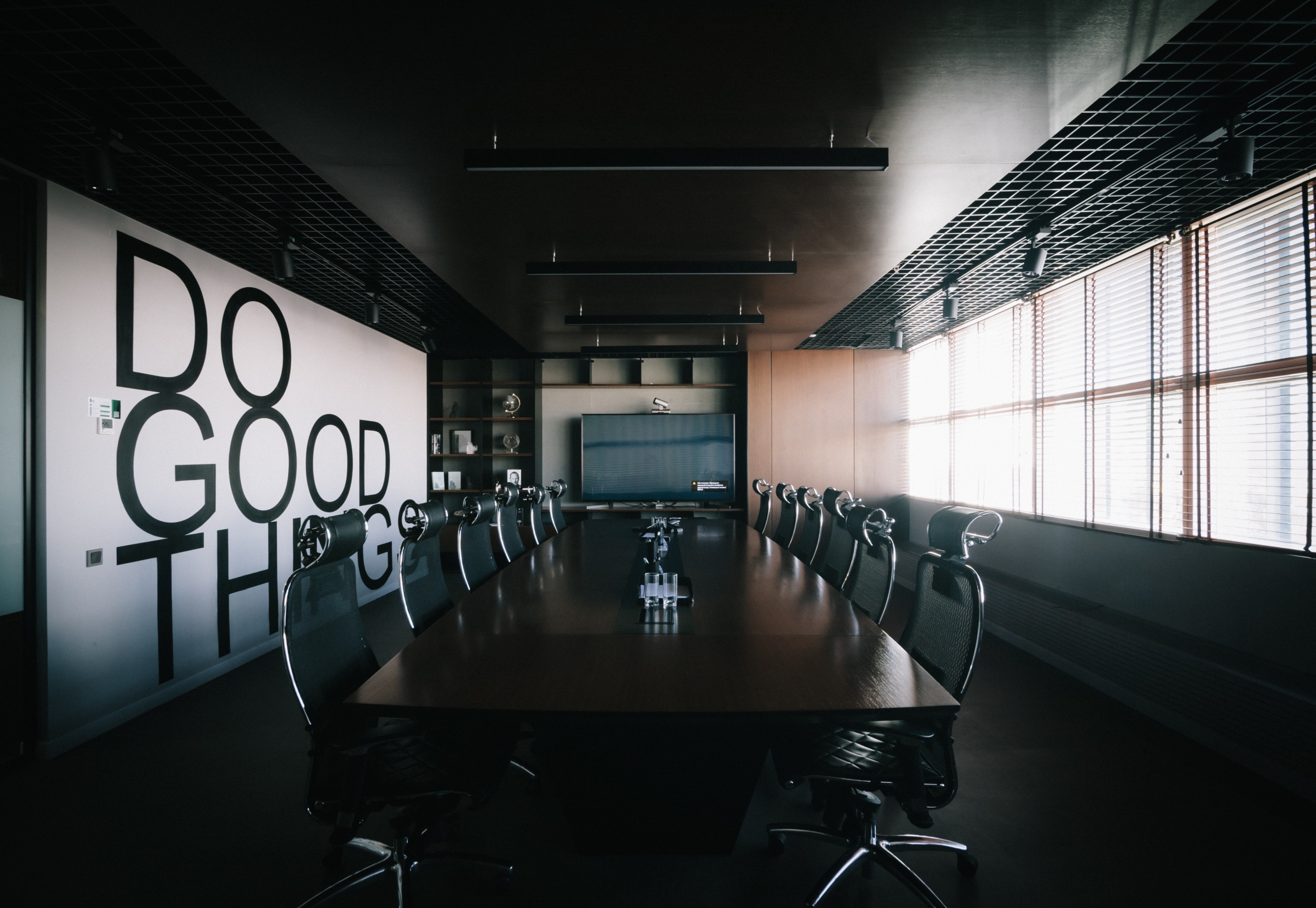 Board room with the words 'do good things' on a wall