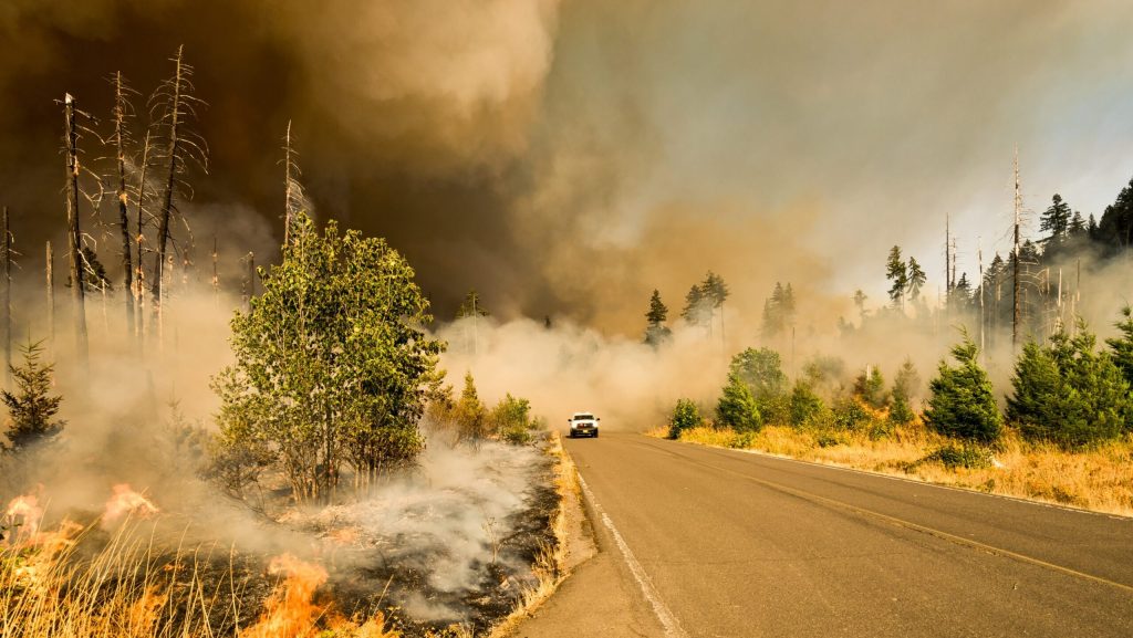 Car drives through smoke from wildfire in the US