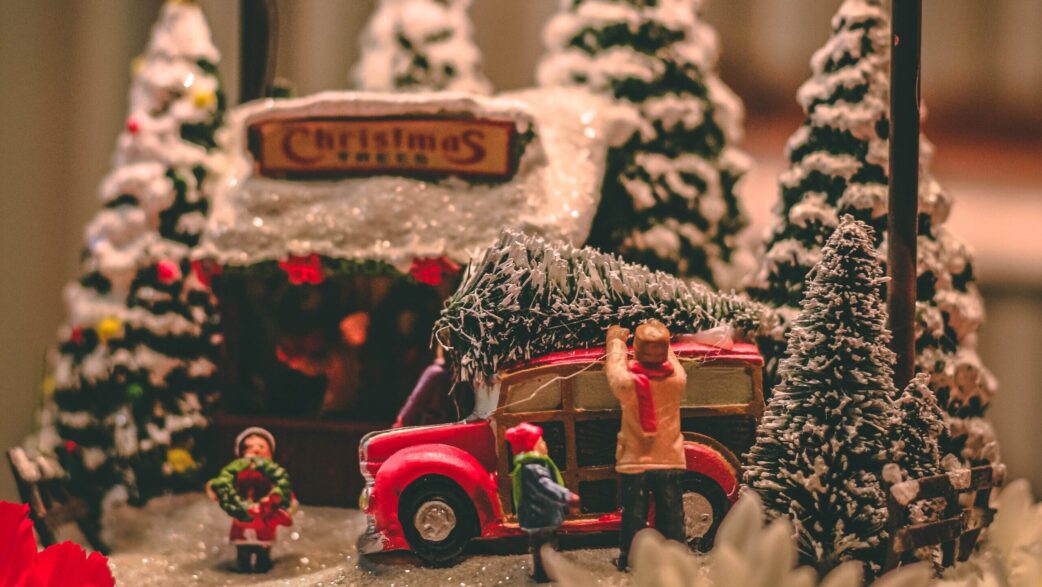 A model Christmas scene with Christmas trees and a red car